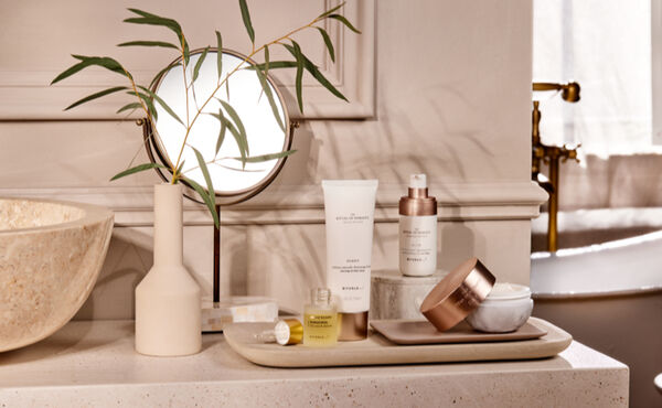 Three women with glowing skin pose together, representing confidence and skincare for all skin types.